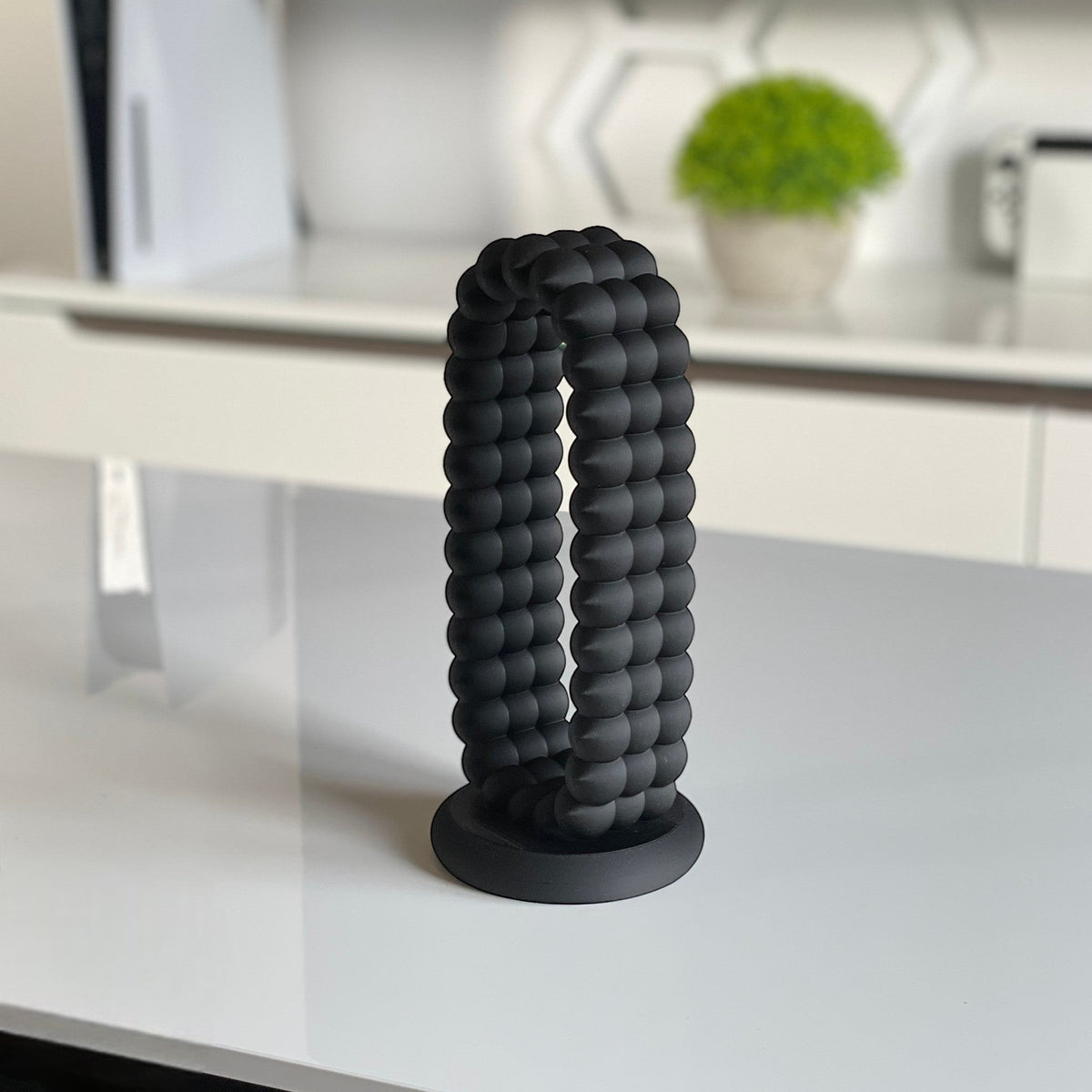 Magicland 3D black bubble-textured headphone stand with a round base, perfect for desktop organization.