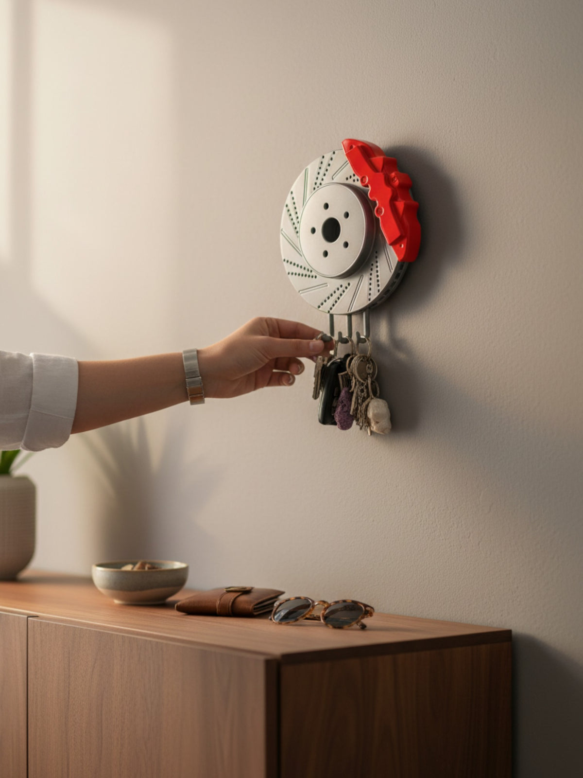 Magicland 3D decorative key holder shaped like a silver brake disc with a red caliper, holding several keys.