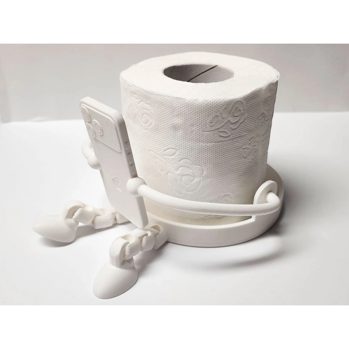 Magicland 3D figürlü beyaz tuvalet kağıdı tutucu, telefon tutma özellikli, eğlenceli ve pratik banyo aksesuarı.