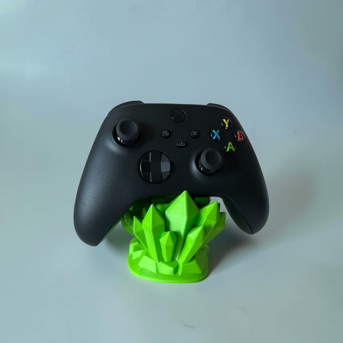 Magicland 3D green crystal controller stand holding a black Xbox controller.
