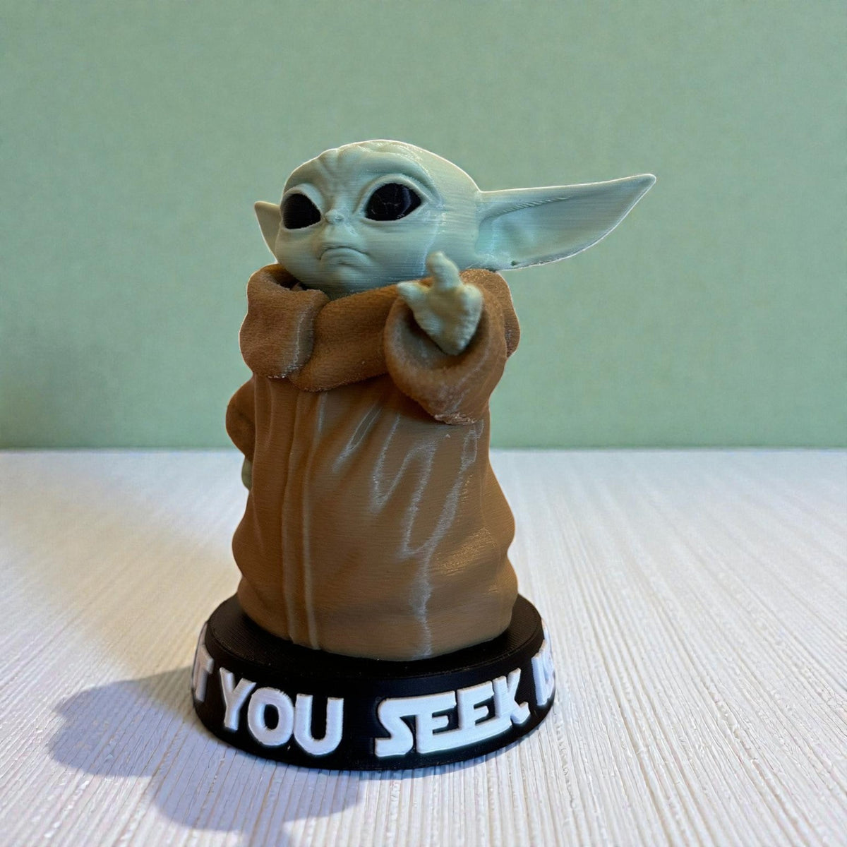 Magicland 3D Grogu Baby Yoda figure in light green and tan, with a quote on the base.