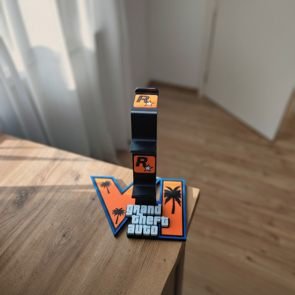Magicland 3D tasarımı, GTA VI temalı palmiye silüetli turuncu logo tabanlı siyah oyun kolu ve kulaklık standı.