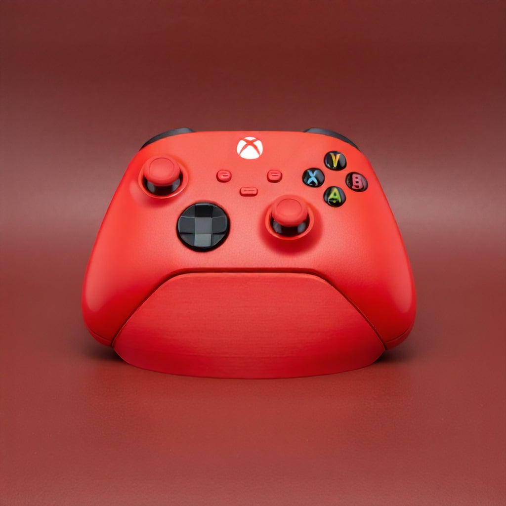 Magicland 3D kırmızı Xbox kol standı, sade ve fonksiyonel tasarım, gaming setup aksesuarı.