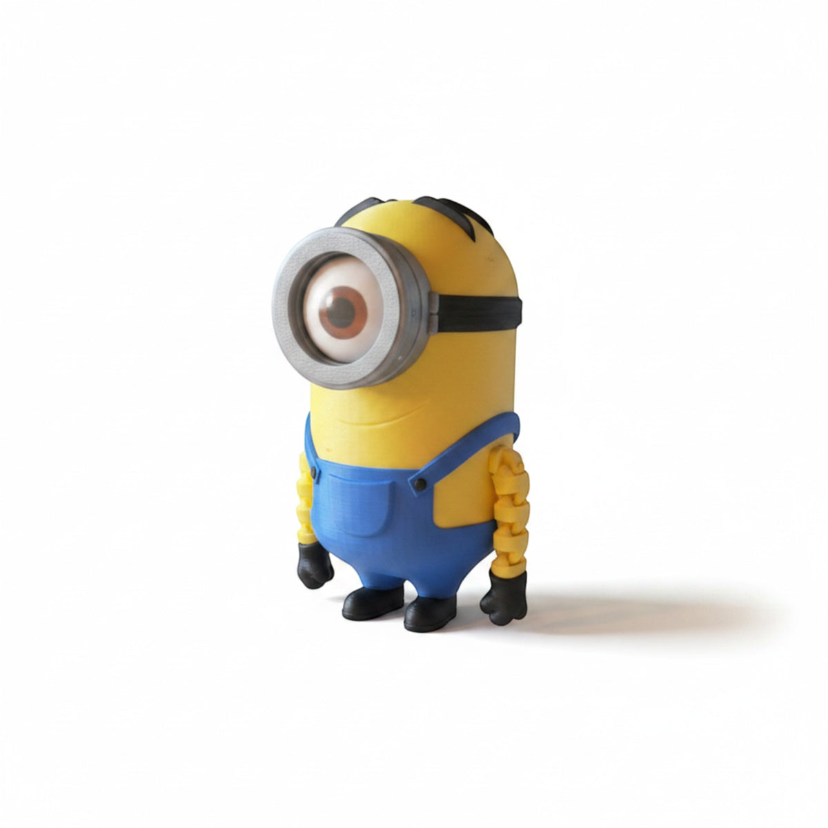 Magicland 3D Minion Flexi Figür, sarı renkli, mavi tulumlu, tek gözlü ve esnek eklemli.