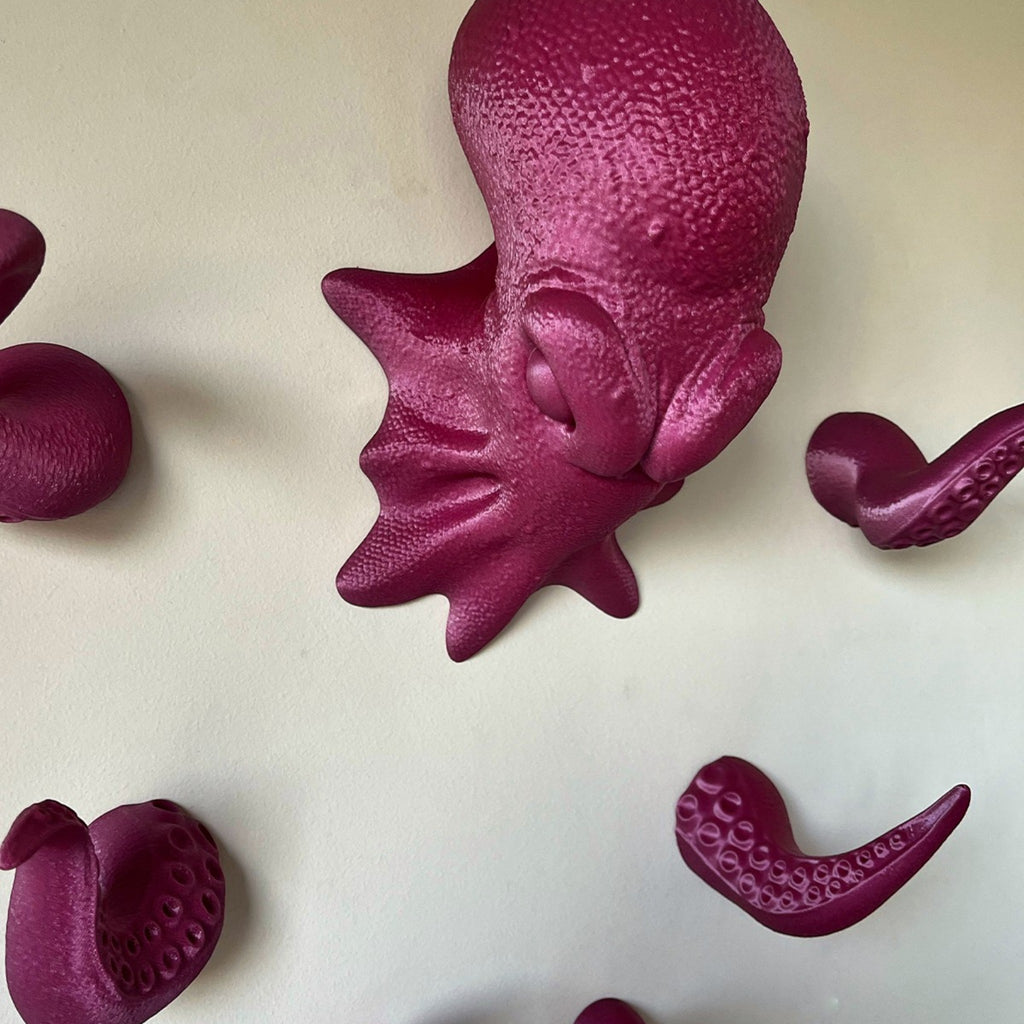 Magicland 3D octopus headphone stand and hooks in a vibrant magenta color, featuring a detailed textured body and tentacles for hanging accessories.