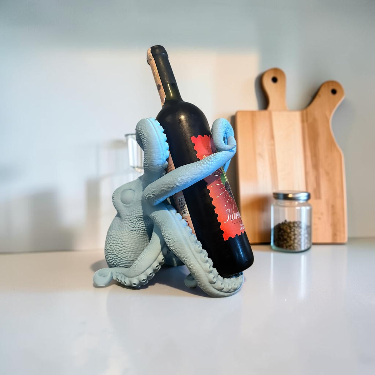 Light blue octopus wine bottle holder by Magicland 3D, featuring detailed tentacles gripping a wine bottle.