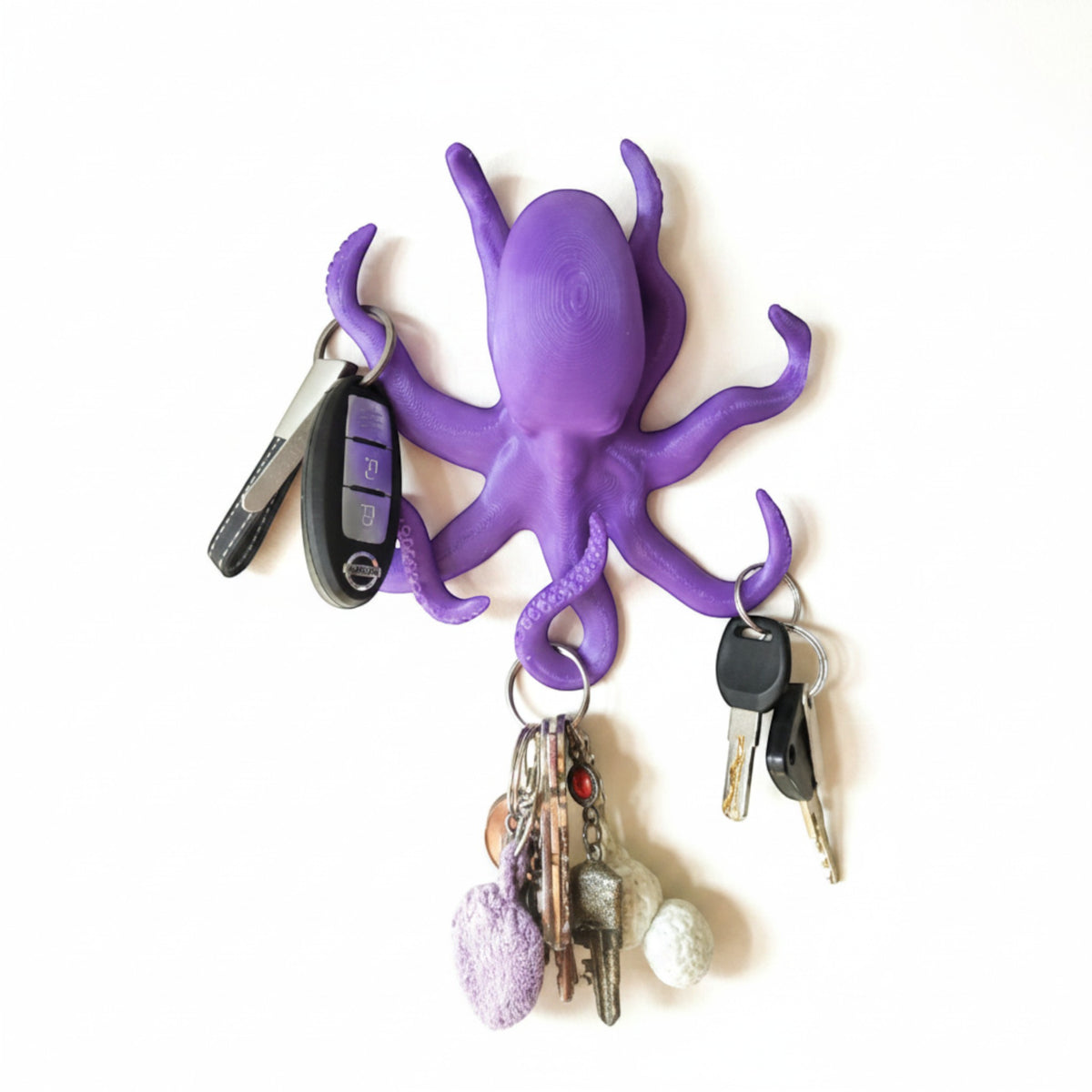 Magicland 3D purple octopus shaped key holder with 3 tentacles holding keys and a keychain.