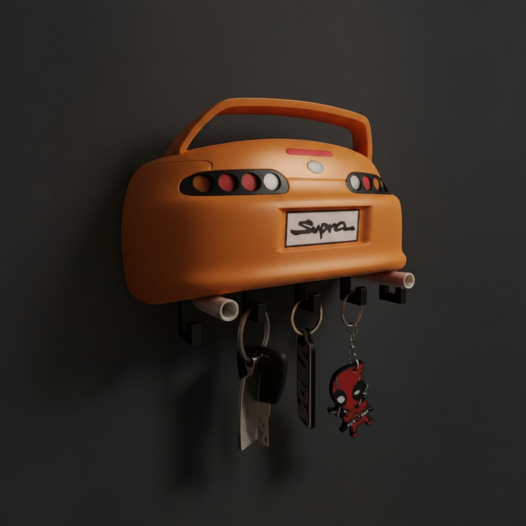 Magicland 3D turuncu Supra MK4 duvar tipi anahtarlık askısı, 5 kancalı, detaylı stop lambaları ve spoiler tasarımıyla.
