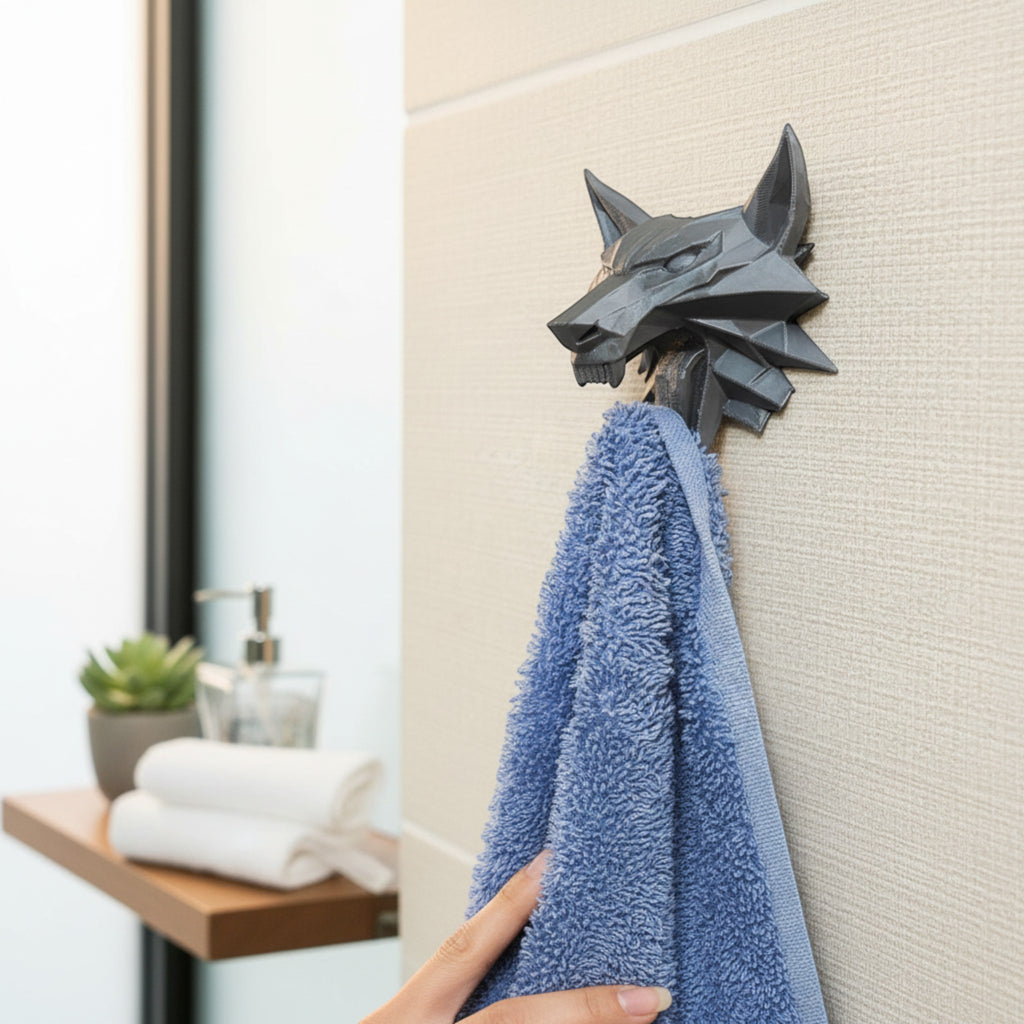 Magicland 3D grey wolf head wall hook holding a blue towel in a bathroom.