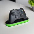 Magicland 3D minimalist black Xbox controller stand with a bright green accent base.