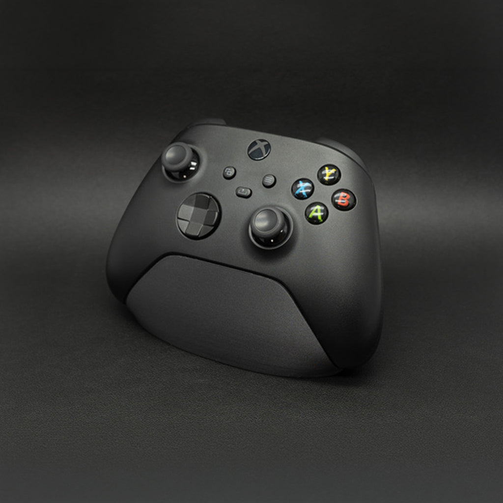 Magicland 3D siyah Xbox kontrolcü standı, oyun kurulumu için sade ve fonksiyonel aksesuar.