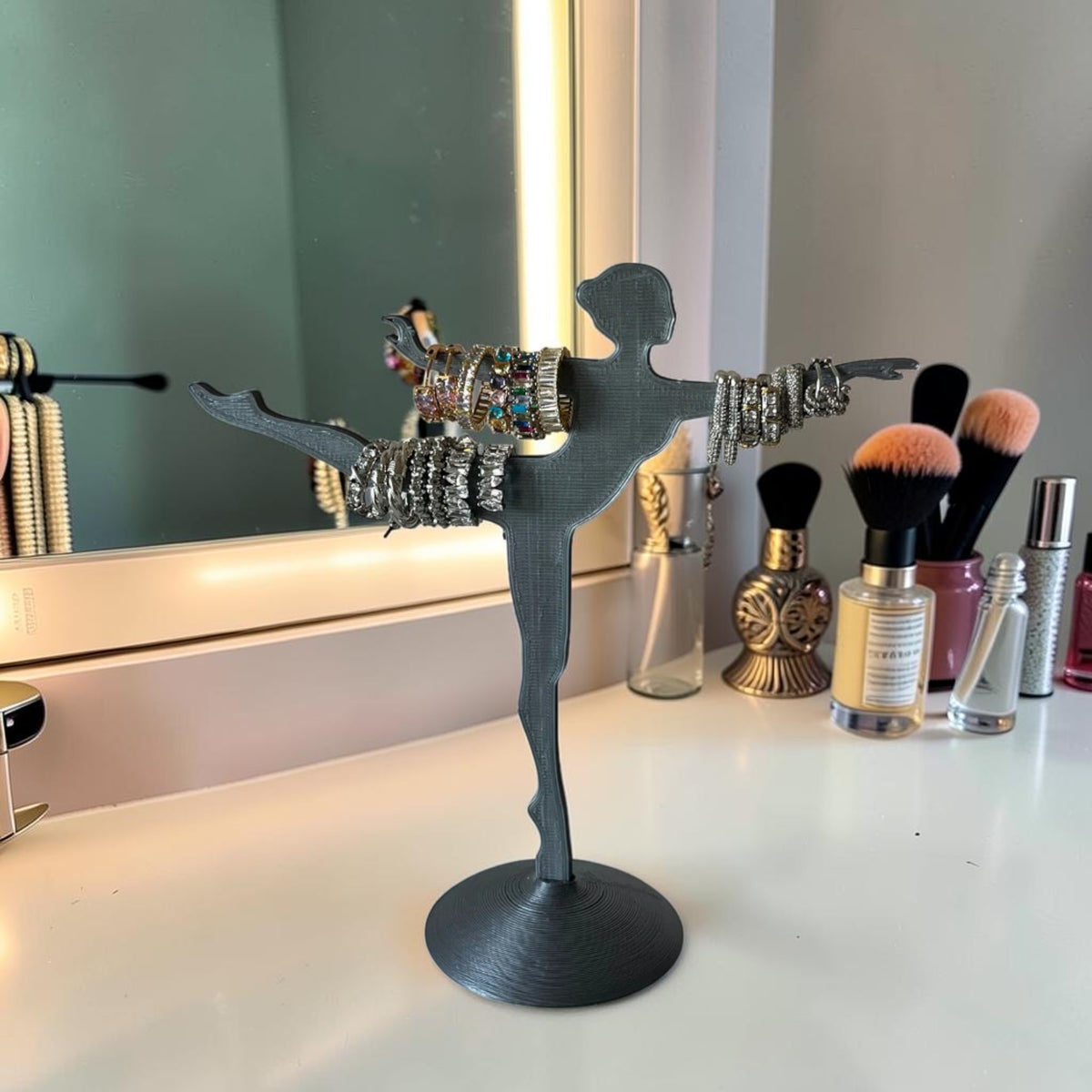 Magicland 3D grey resin ballerina jewelry stand holding bracelets and rings. Decorative and functional.