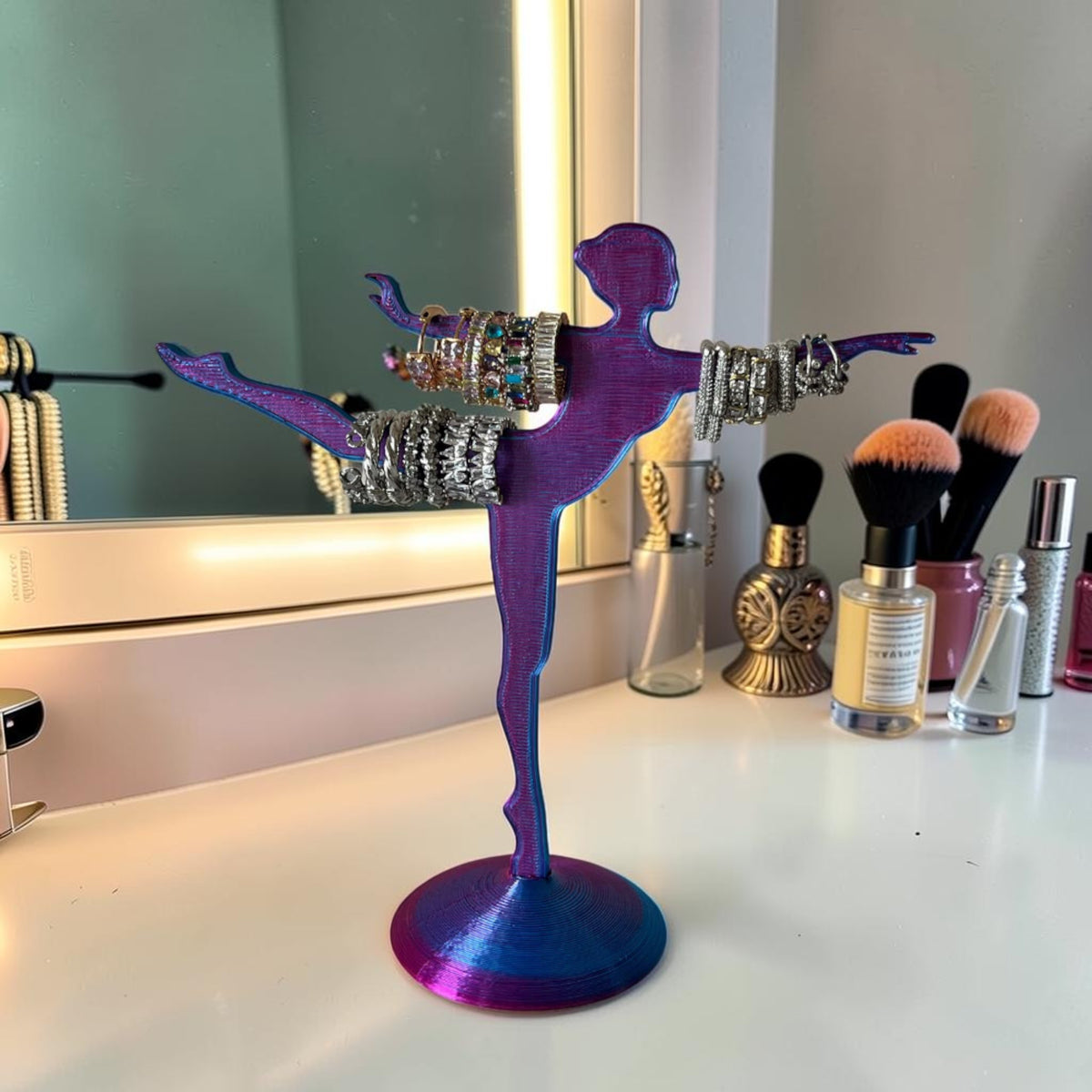 Magicland 3D purple and blue iridescent ballerina jewelry stand holding rings and bracelets.