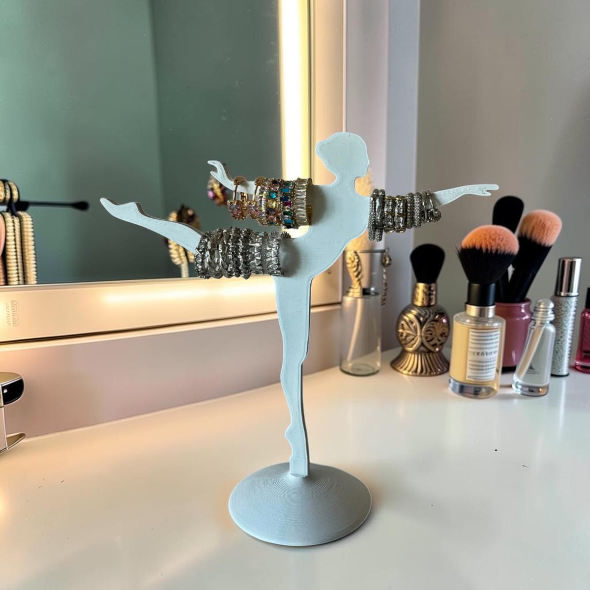 Magicland 3D white ballet dancer jewelry stand holding rings and bracelets. Decorative and functional.