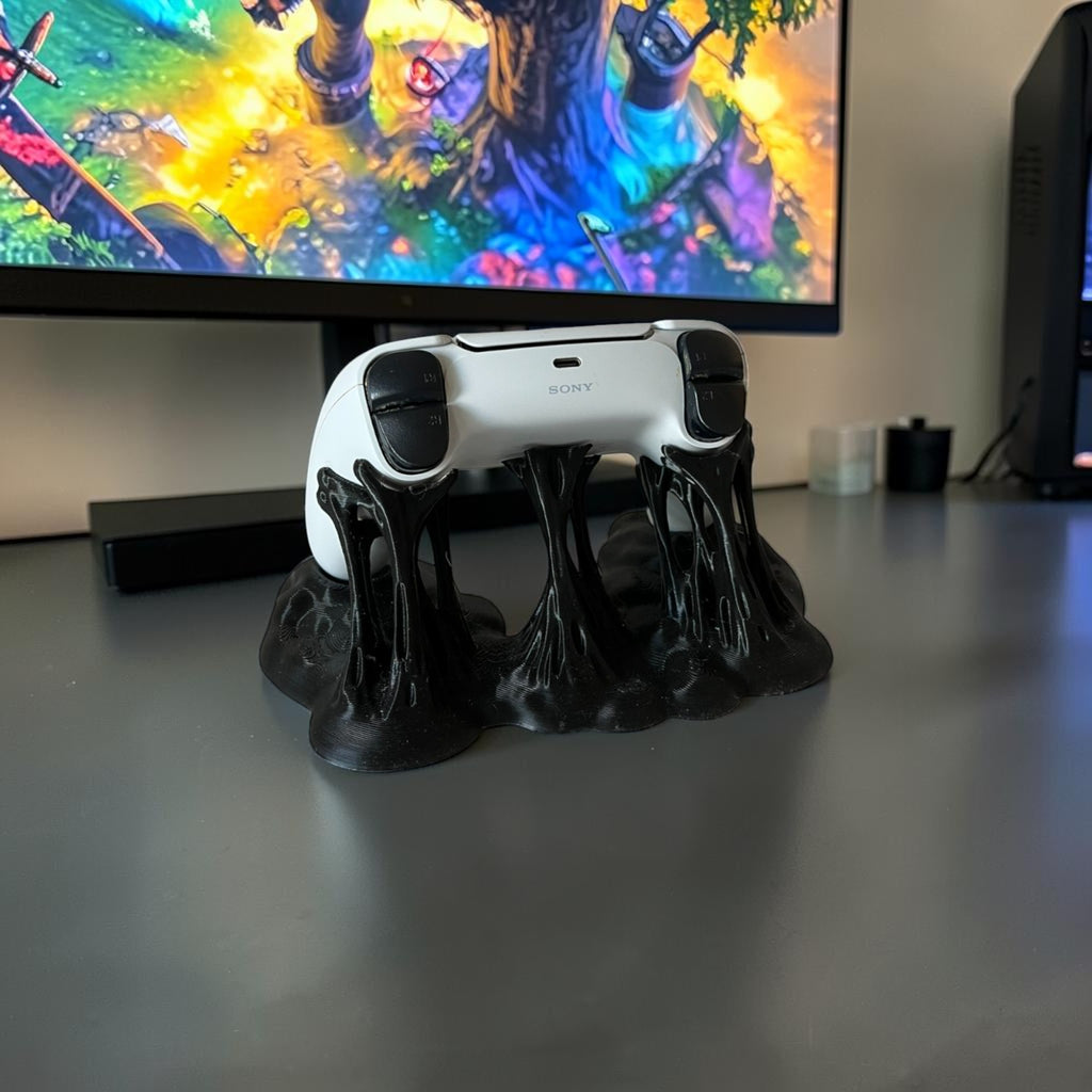 Magicland 3D black sticky effect controller stand holding a white PlayStation controller.