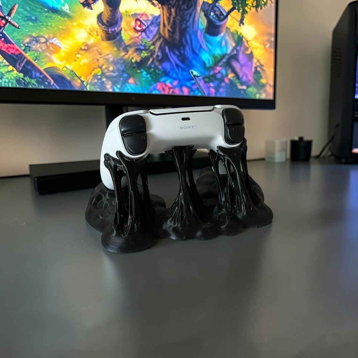 Magicland 3D black sticky effect controller stand holding a white PlayStation controller.