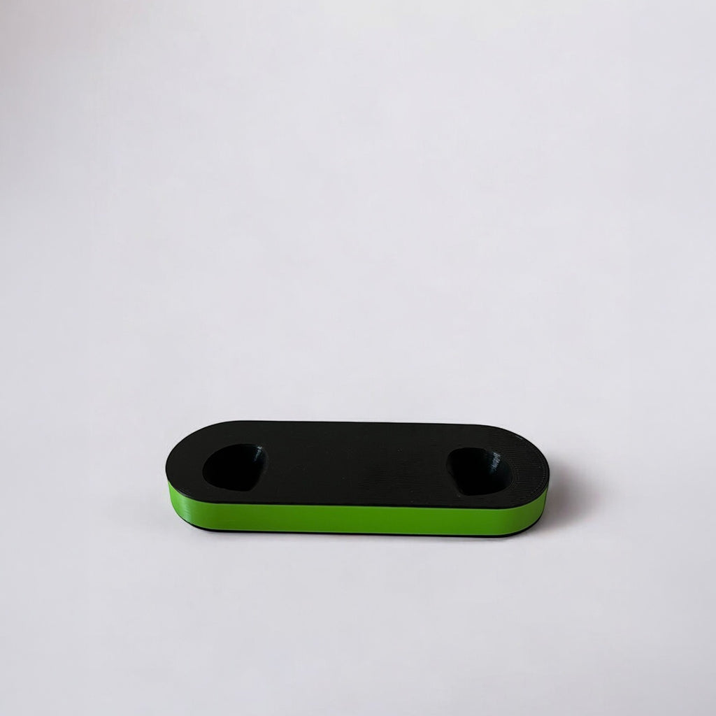 Magicland 3D black dual controller stand with a bright green base, minimalist design.