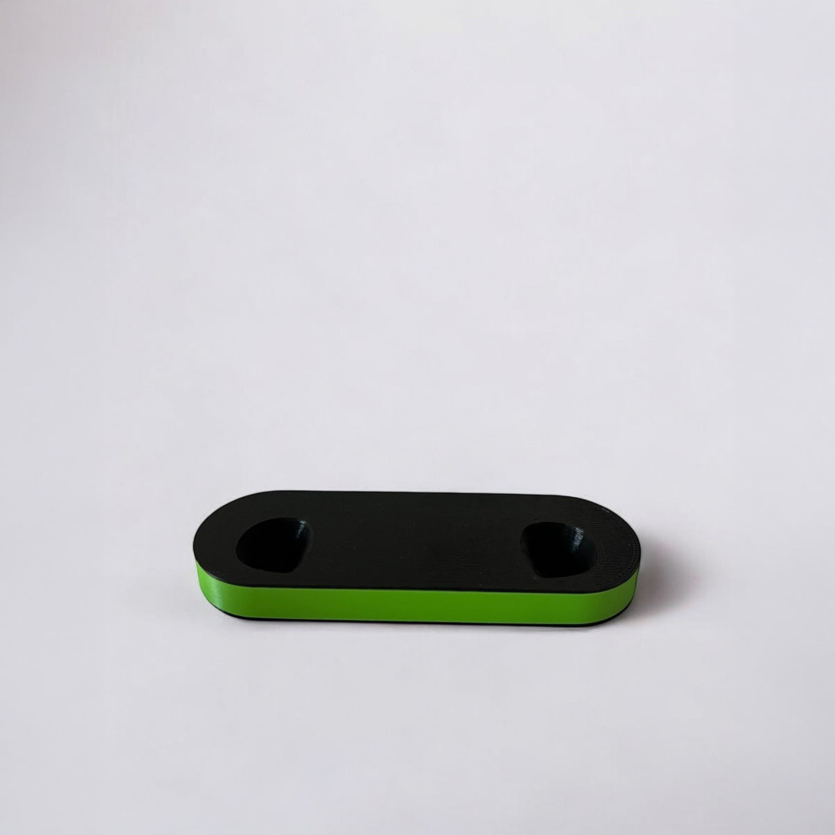 Magicland 3D black dual controller stand with a bright green base, minimalist design.