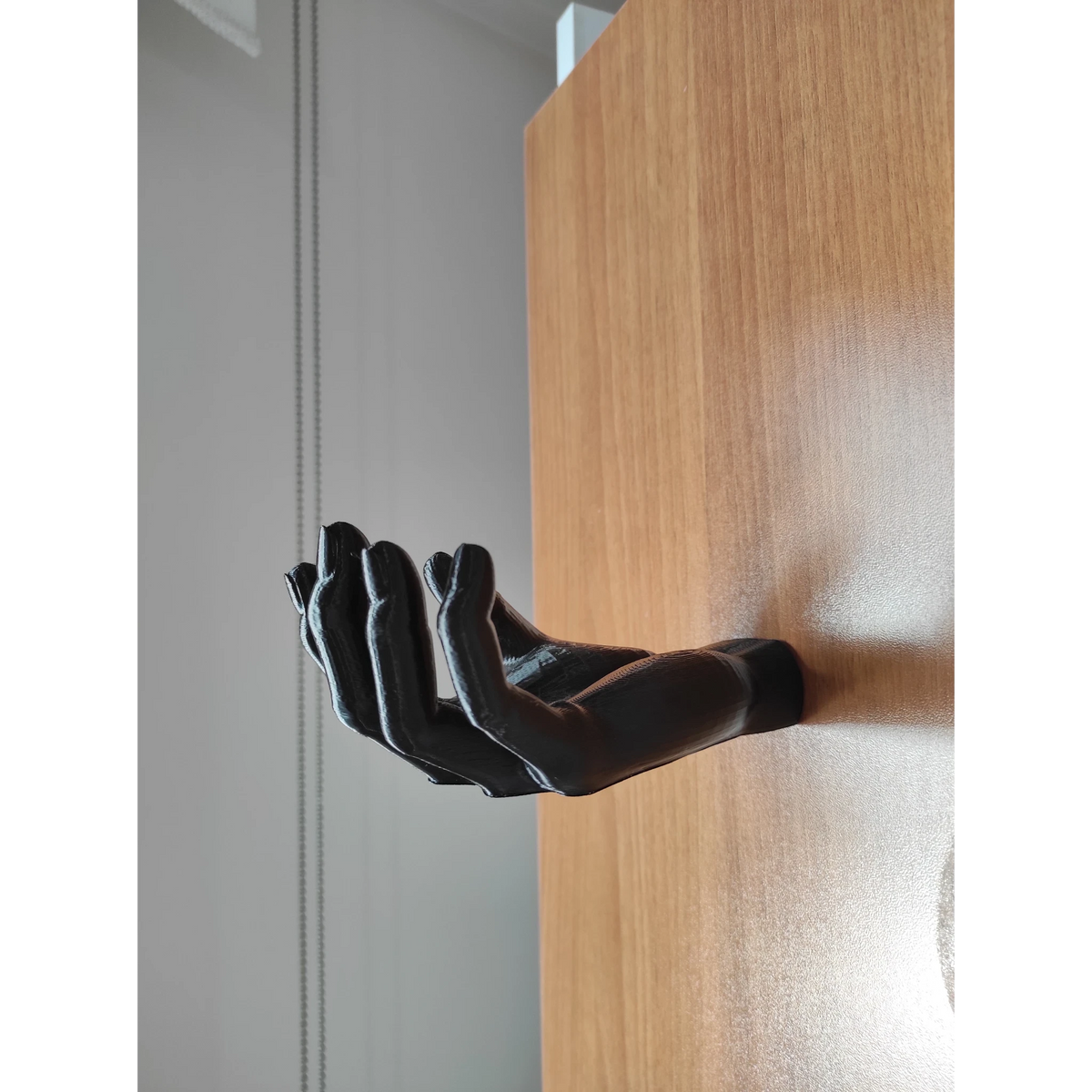 Magicland 3D black hand-shaped headphone stand, unique decorative desk accessory.