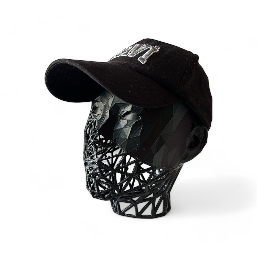 Magicland 3D black Voronoi patterned headphone stand shaped like a face, wearing a black baseball cap.