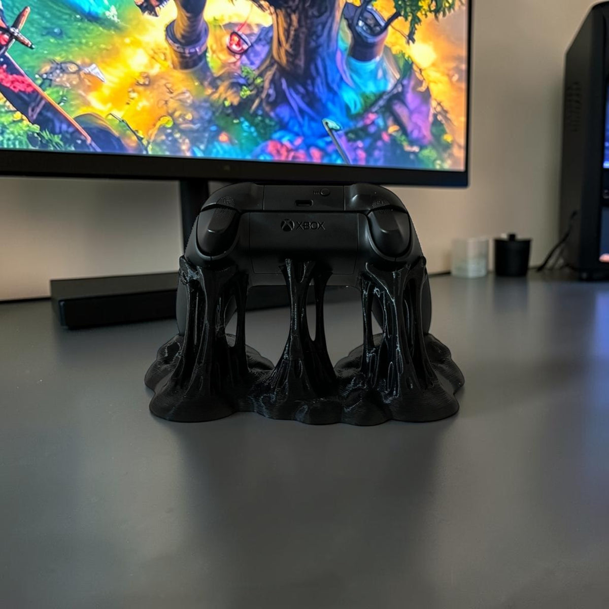 Black Xbox controller stand with a dripping, sticky effect. Holds one controller.