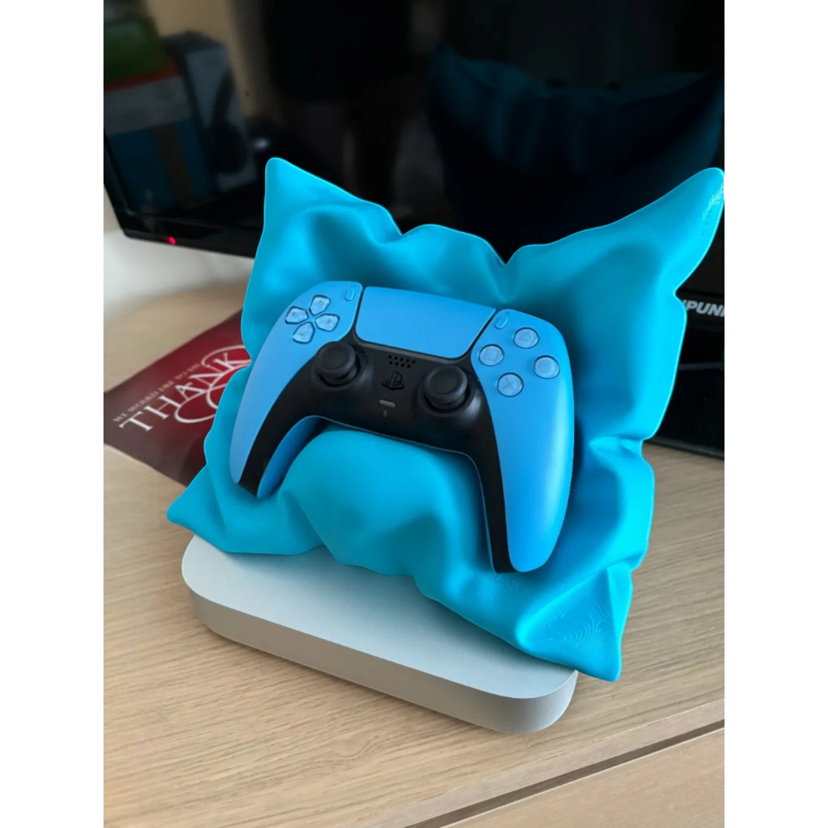 Magicland 3D blue decorative pillow-shaped stand holding a blue PlayStation controller.