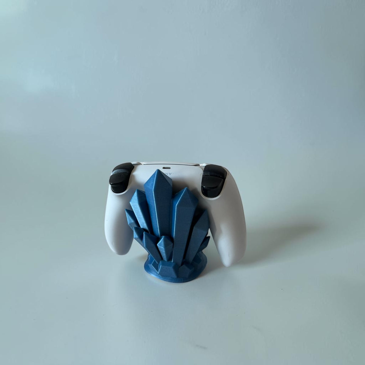Magicland 3D blue crystal controller stand for PlayStation 5 controller.