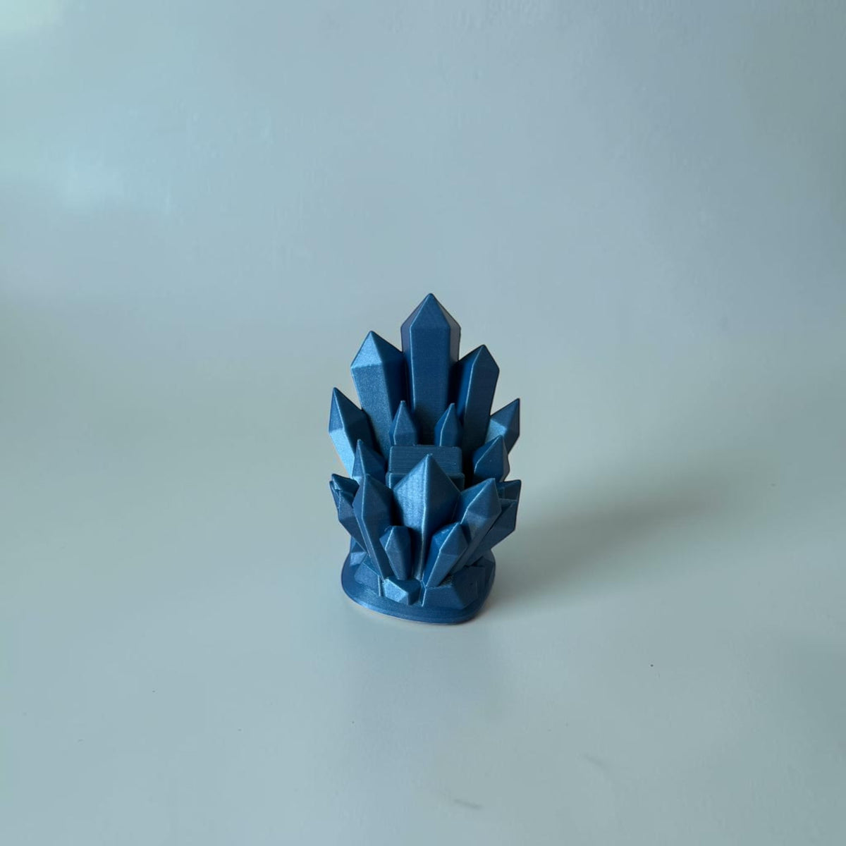 Magicland 3D blue crystal design decorative stand, metallic finish, geometric facets.