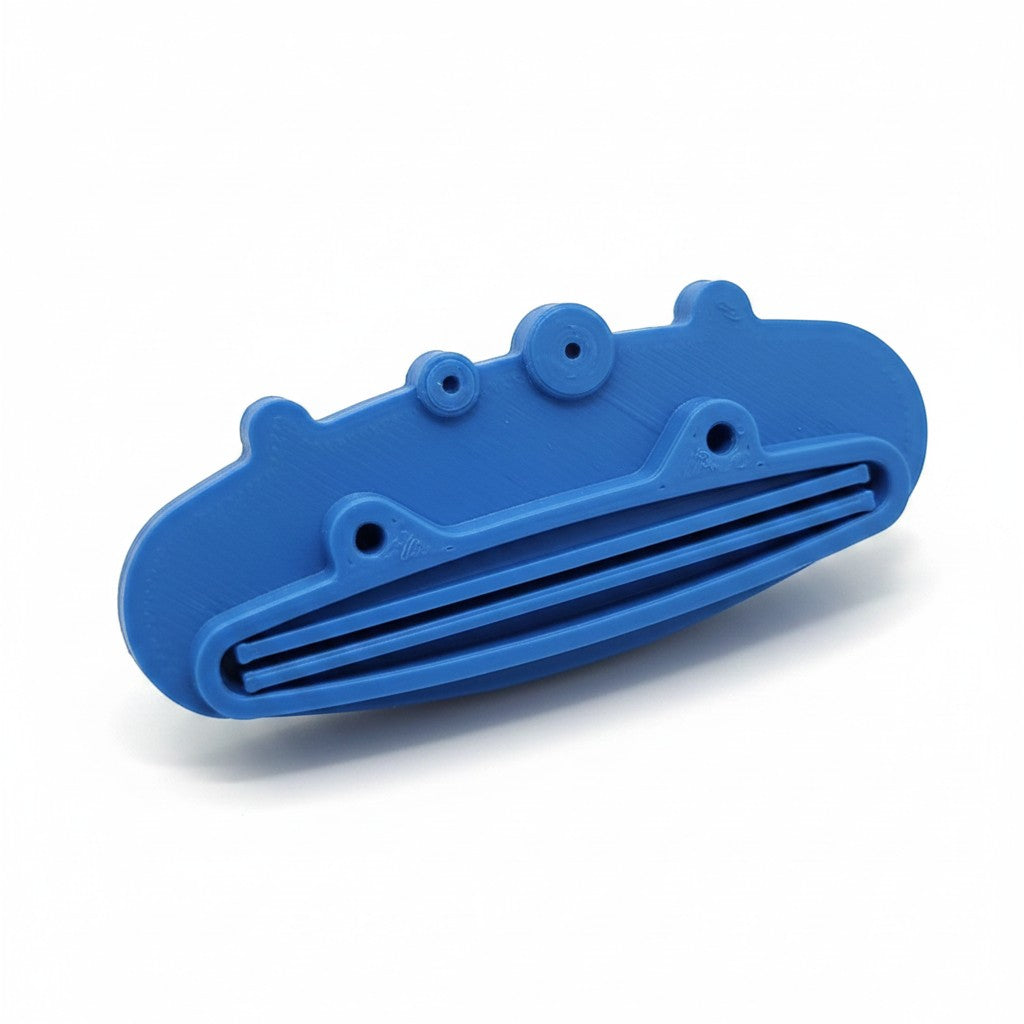 Magicland 3D blue pig-shaped toothpaste dispenser with slots for squeezing.
