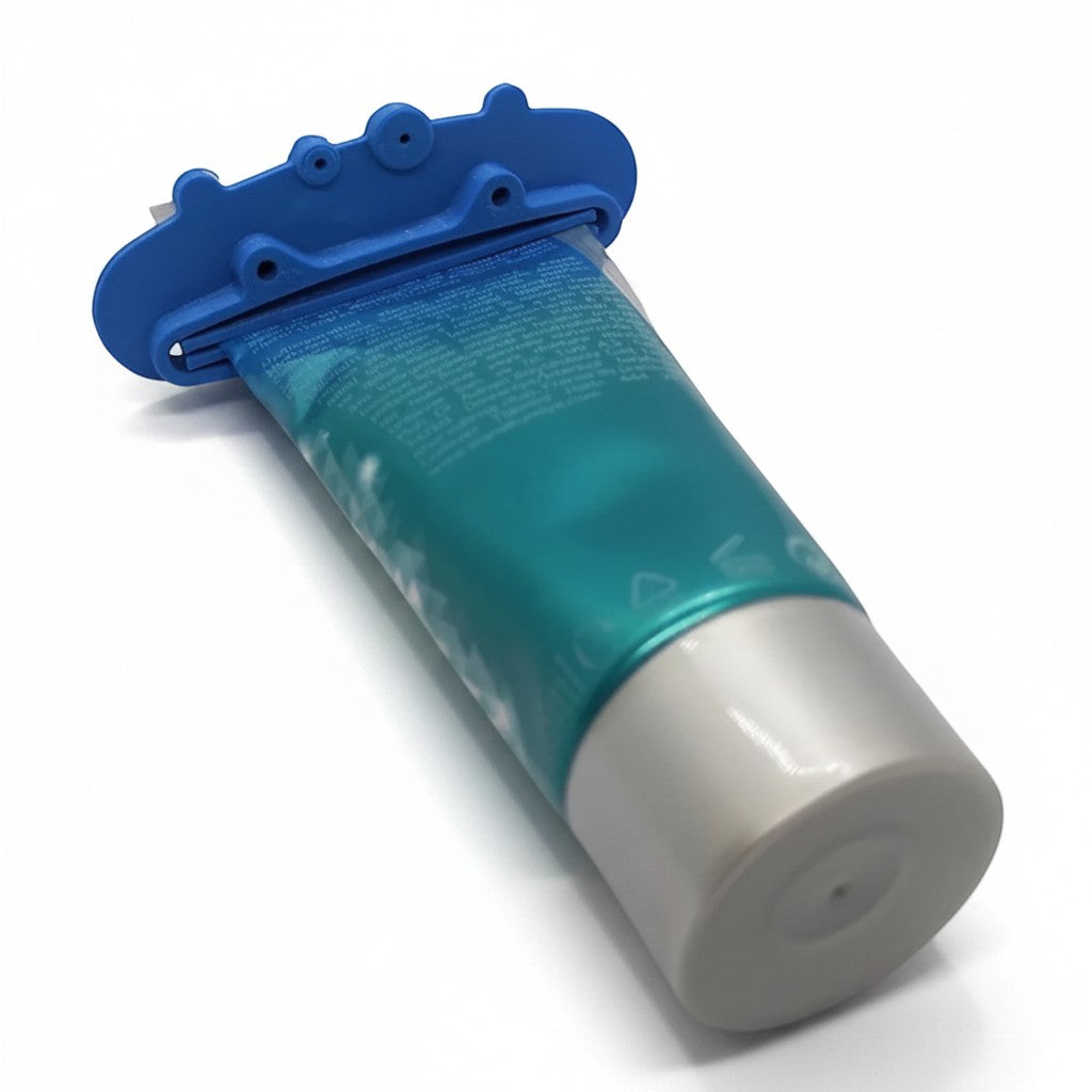 Magicland 3D blue pig-shaped toothpaste squeezer attached to a teal and silver toothpaste tube.