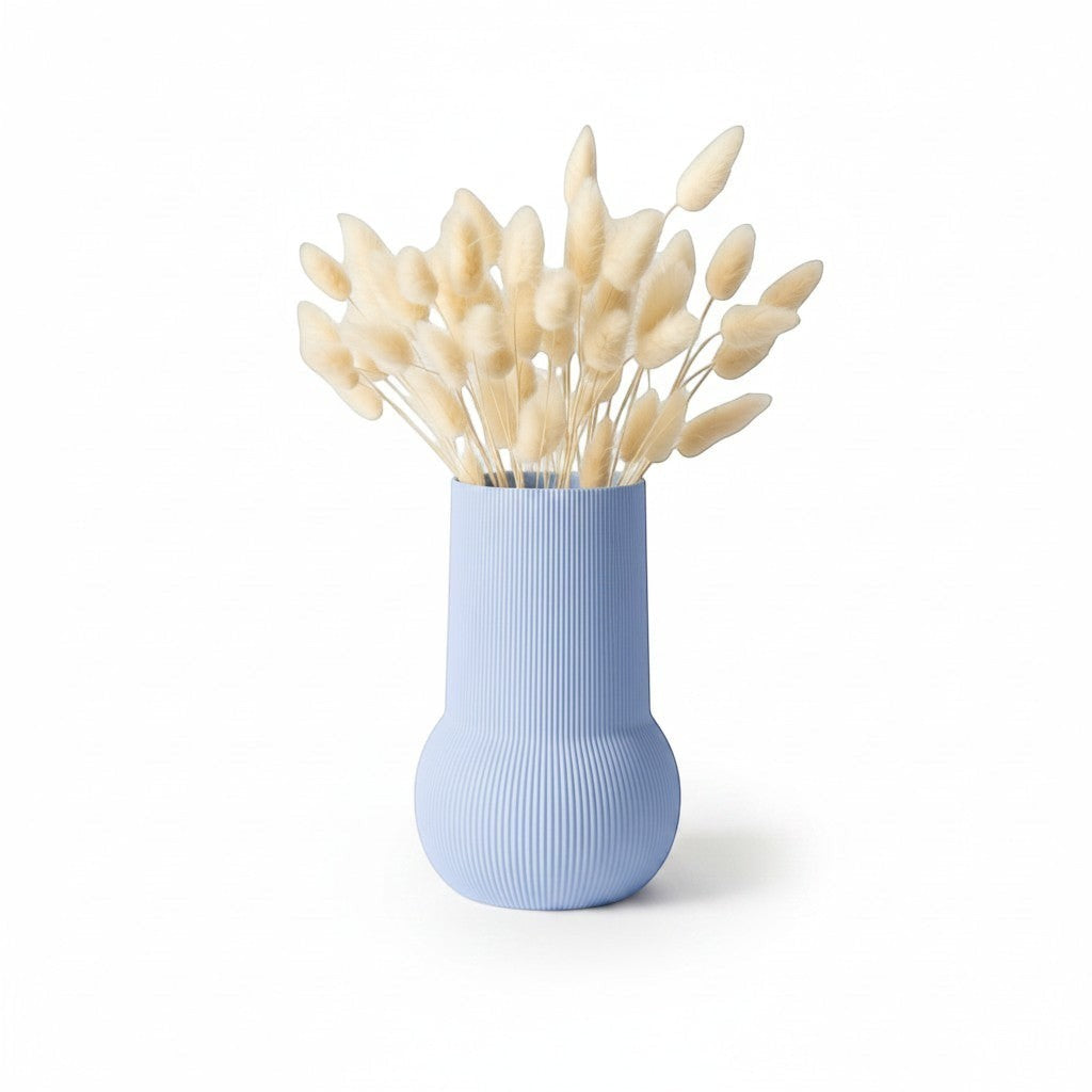 Magicland 3D decorative vase in light blue with ribbed texture, holding dried bunny tail grass.
