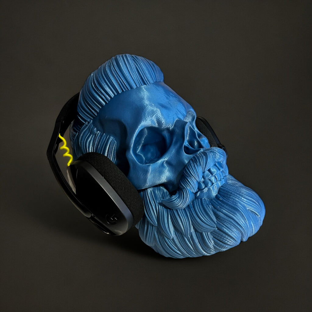 Magicland 3D blue skull headphone stand with beard and stylized hair, holding black headphones.