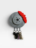 Magicland 3D grey brake disc key holder with red caliper detail, holding several keychains.