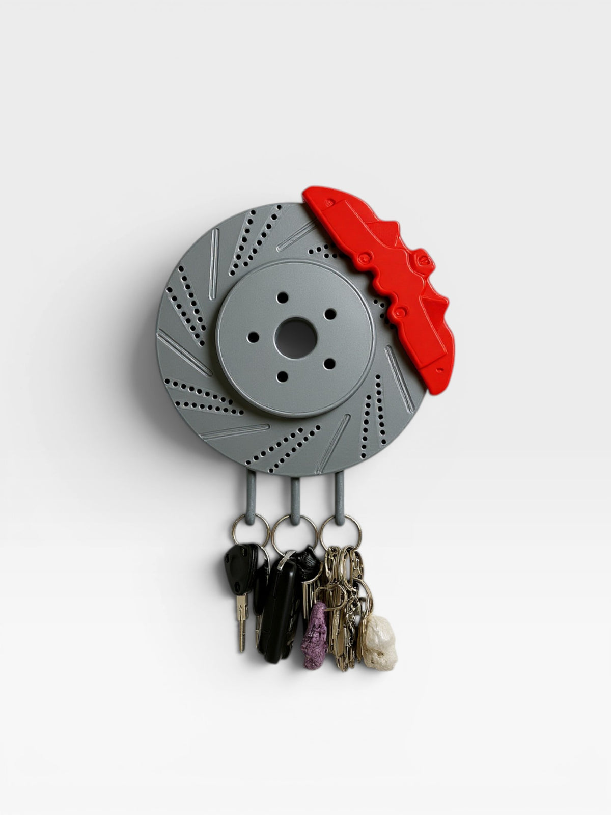 Magicland 3D grey brake disc key holder with red caliper detail, holding several keychains.