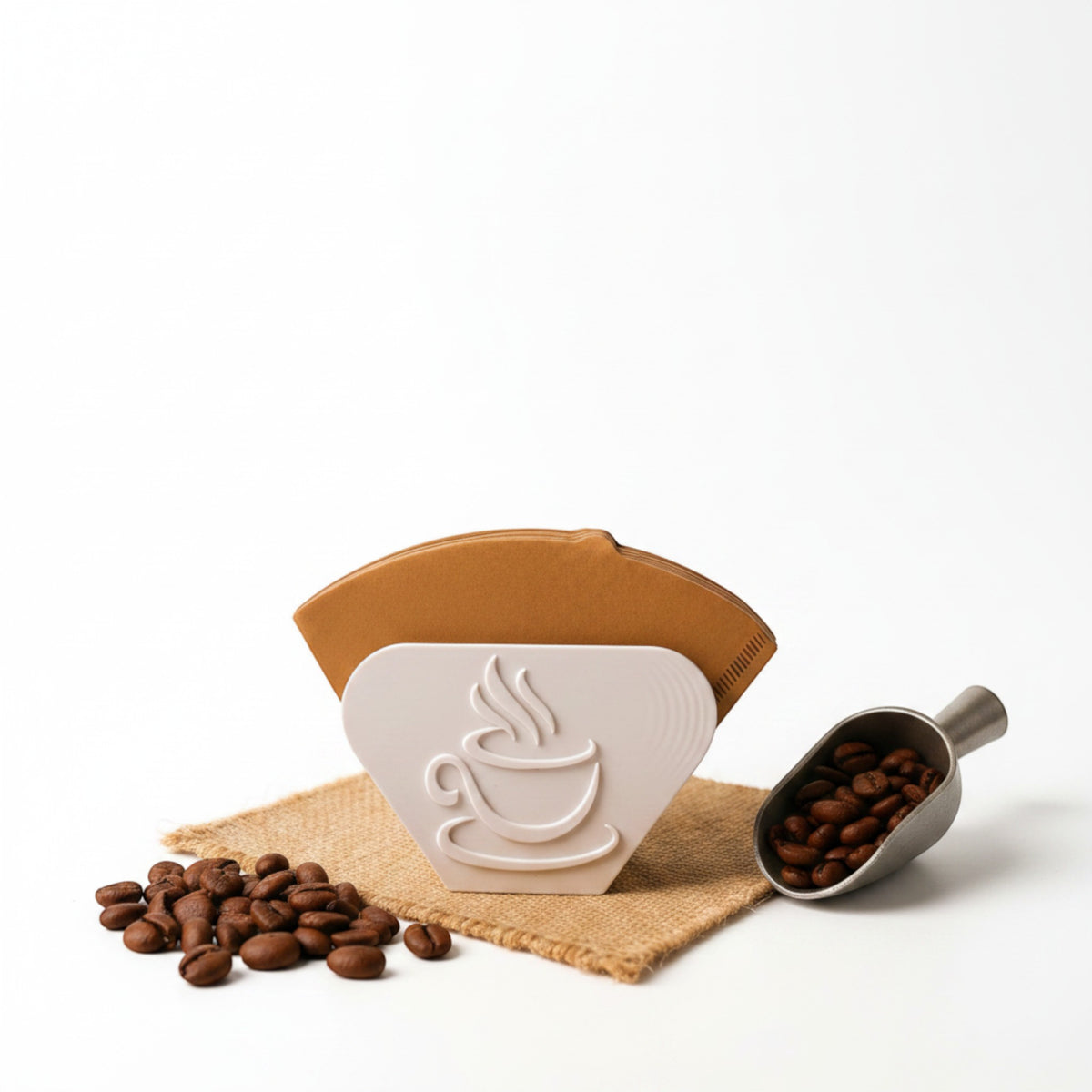 Magicland 3D white coffee filter holder stand with embossed coffee cup design, holding brown paper filters. Coffee beans and scoop nearby.