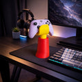 Magicland 3D hand-shaped controller stand in red, yellow, and purple, holding a light purple Xbox controller.