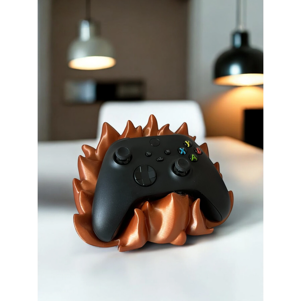 Magicland 3D copper flame-themed controller stand holding a black Xbox controller. Unique gaming accessory.