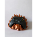 Magicland 3D flame-themed controller stand in copper, holding a black Xbox controller.