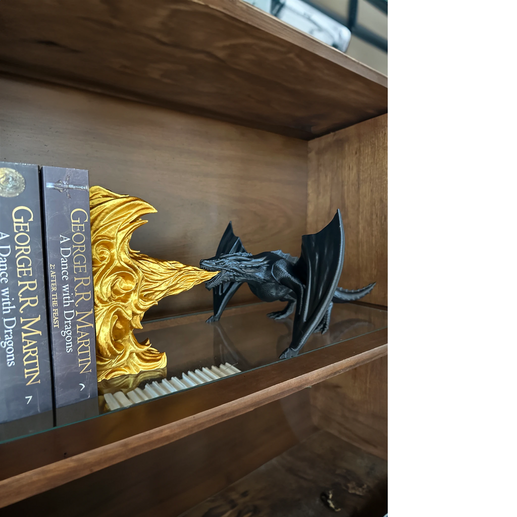 Magicland 3D black dragon breathing golden fire, decorative bookend for fantasy novels.