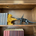 Magicland 3D black dragon breathing golden fire, decorative bookends on a wooden shelf.