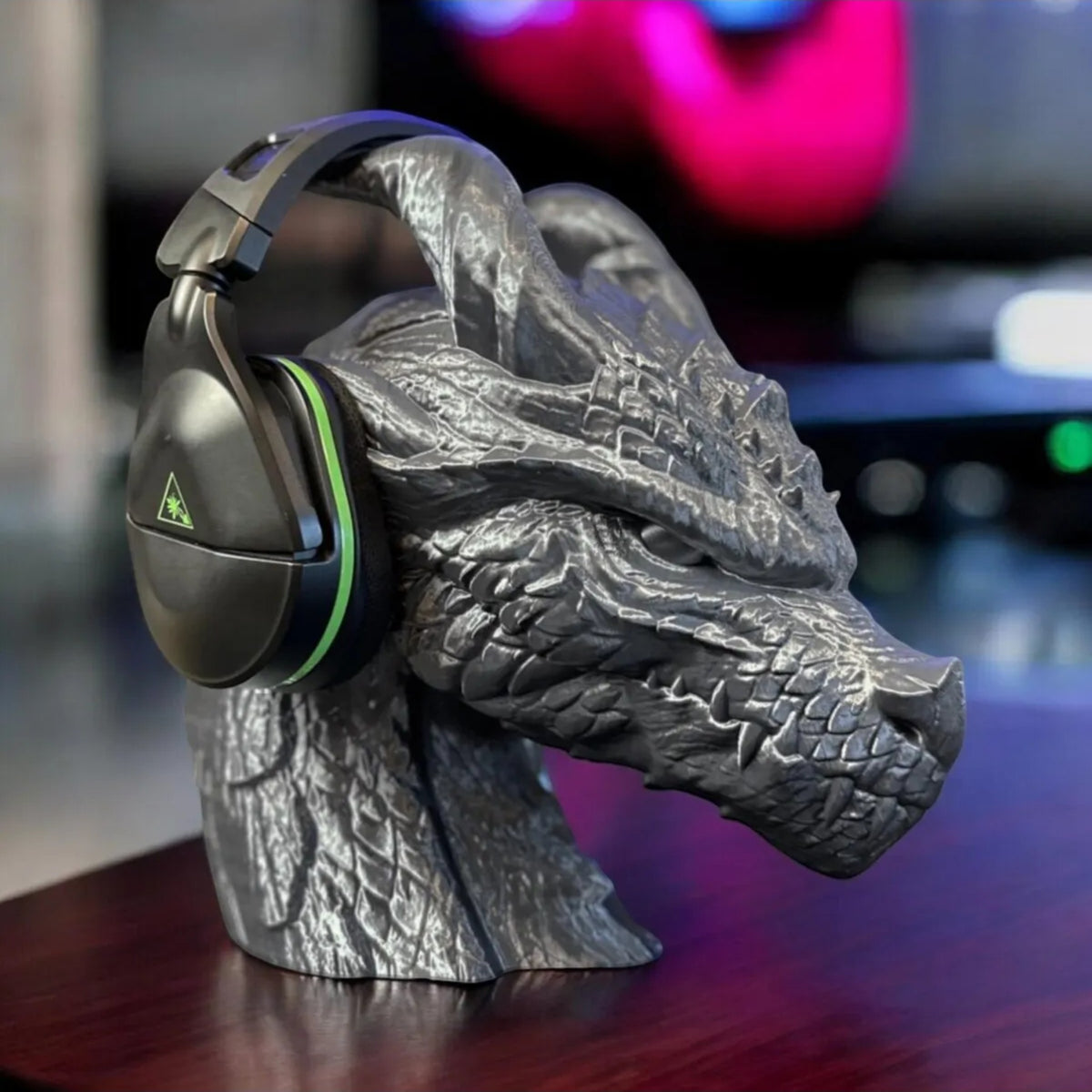 Magicland 3D grey dragon head headphone stand with black and green gaming headset