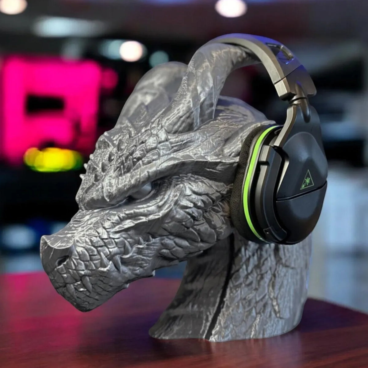 Magicland 3D grey dragon head headphone stand with black and green gaming headset