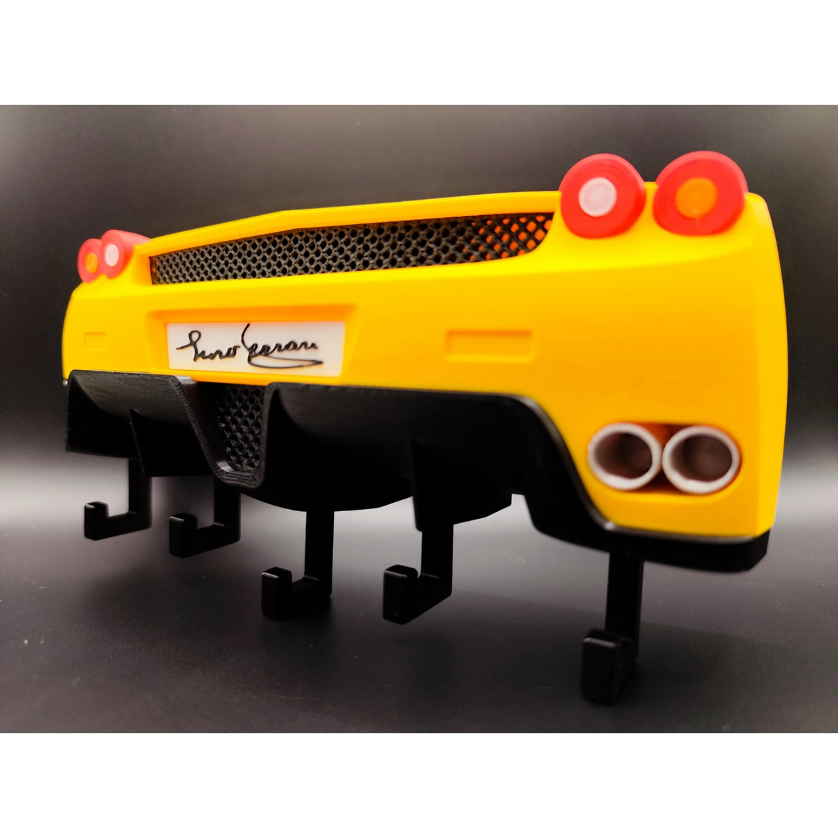 Magicland 3D yellow Ferrari Enzo rear end key holder with black diffuser and exhaust pipes.