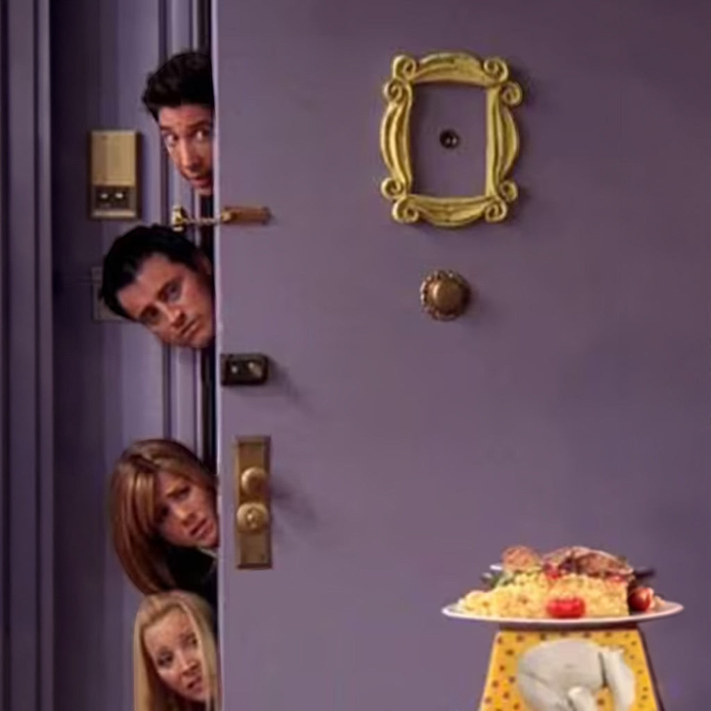 Magicland 3D Friends Monica decorative door ornament, a yellow ornate frame on a purple door.