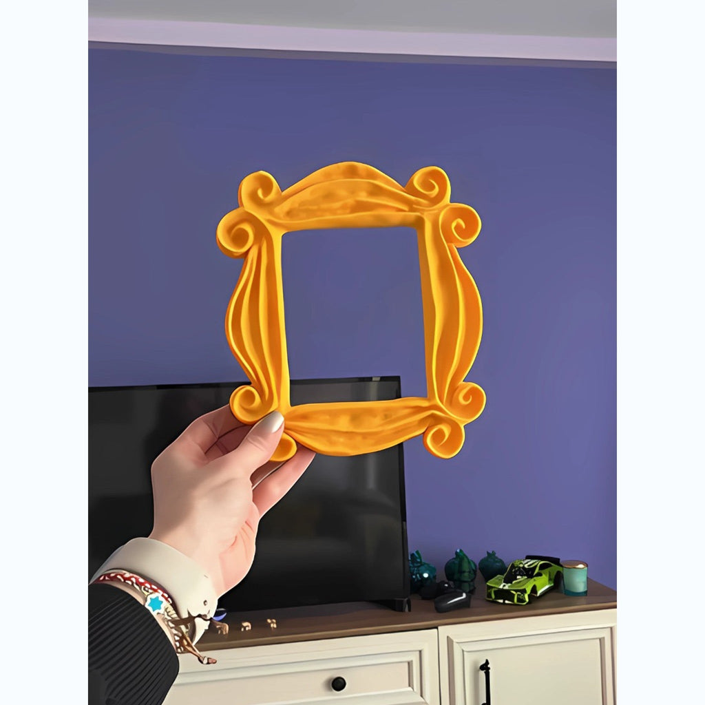 Magicland 3D yellow decorative door frame inspired by Friends TV show, held by a hand.