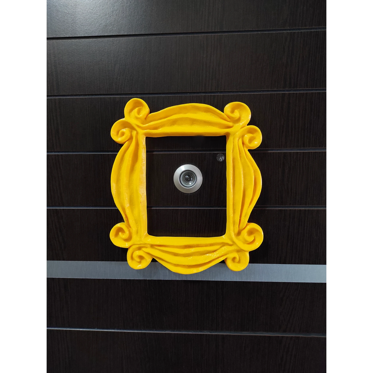 Magicland 3D yellow decorative door frame inspired by Friends, with ornate swirls.