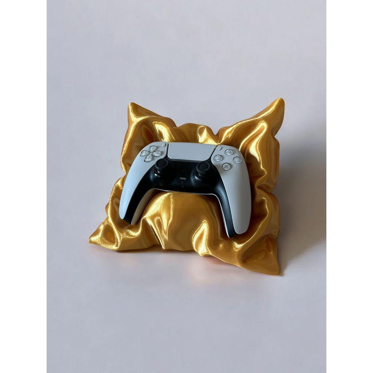 Magicland 3D decorative pillow-shaped stand for PlayStation 5 controller, gold finish.