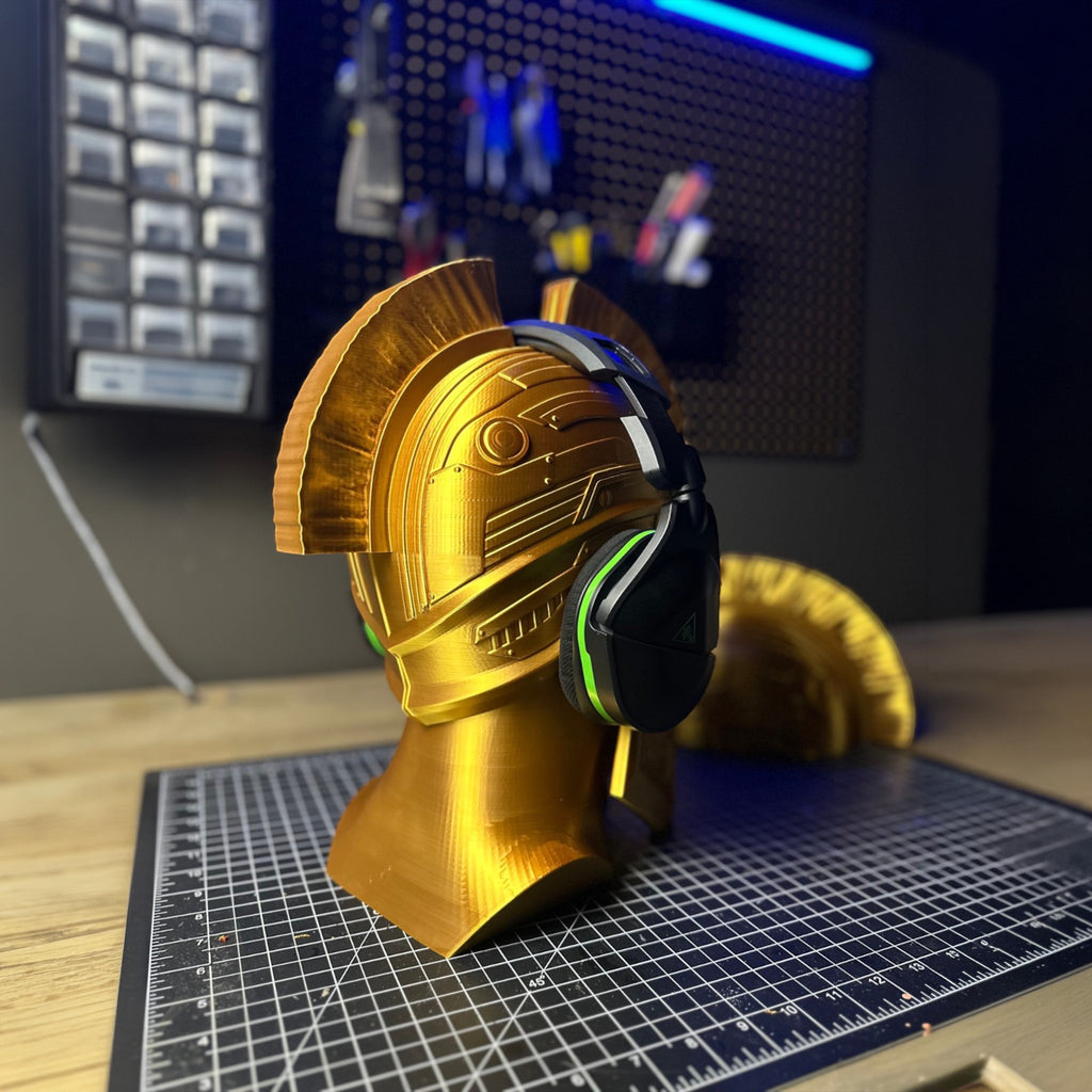 Gold Gladiator helmet headphone stand by Magicland 3D, featuring intricate details and a unique design for storing gaming headsets.