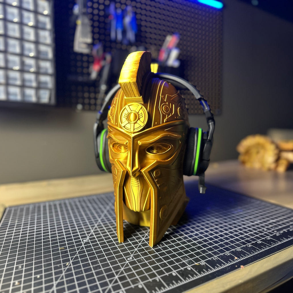Magicland 3D gold gladiator helmet headphone stand with green accented headphones.
