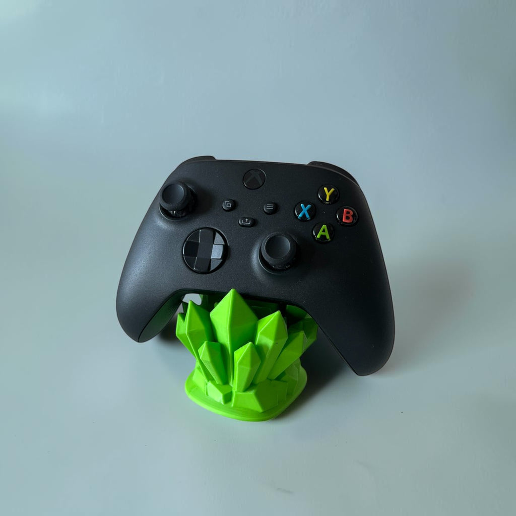 Magicland 3D green crystal controller stand holding a black Xbox controller. Unique gaming accessory.